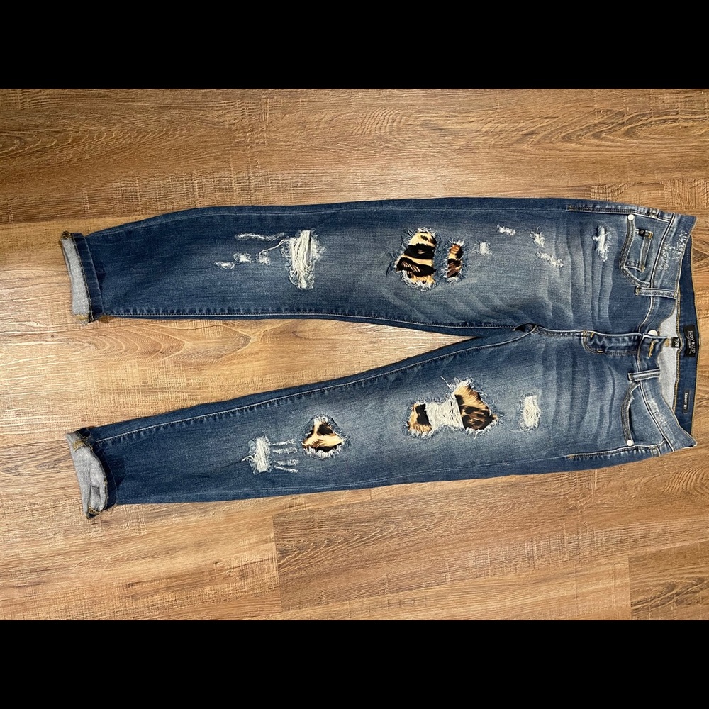 distressed jeans with leopard print detail